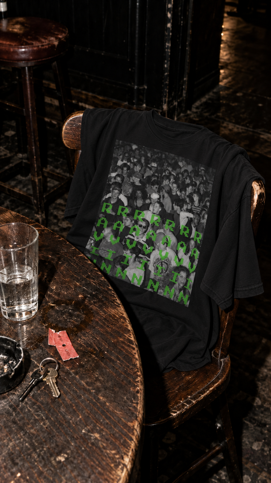 Black Ravin Tee displayed on a pub chair – AmplifyDestroy After the Gig campaign
